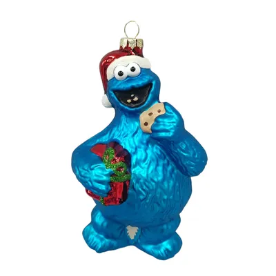 A Christmas ornament of the Sesame Street character Cookie Monster wearing a Santa hat and holding a present and a cookie.