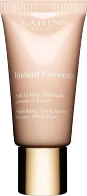 A tube of Clarins Instant Concealer with a gold cap, presented on a white background.