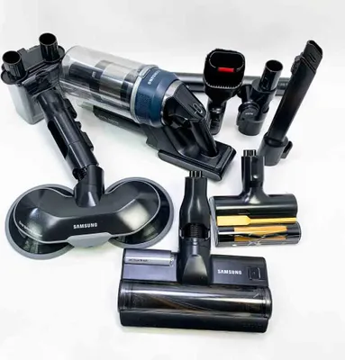 A collection of Samsung vacuum cleaner attachments and the main unit are laid out on a white surface.