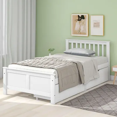 A white wooden bed with two drawers is shown in a bedroom with light green walls and white curtains.