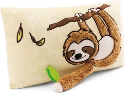 A plush sloth toy hanging from a branch on a pillow.