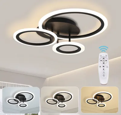 A modern LED ceiling light with multiple rings, shown on a white ceiling. A remote control is also visible.