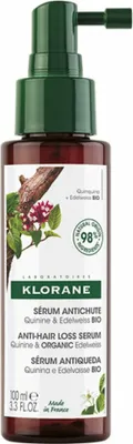 A bottle of Klorane hair loss serum with quinine and edelweiss.