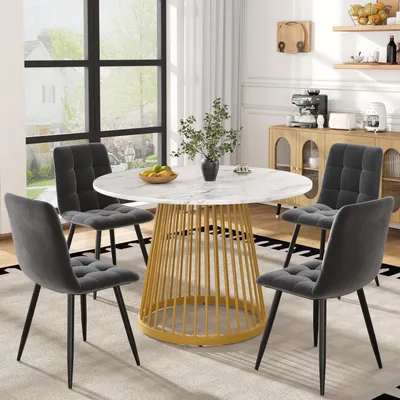 Image de Ensemble de salle à manger comprenant une table et 4 chaises. Table ronde de 80x80x76 cm avec plateau blanc et pieds en métal doré. Chaises en velours