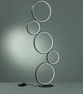 A modern floor lamp with multiple circular elements.