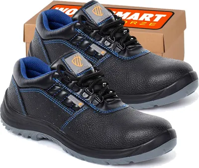 A pair of black work boots is shown in front of a cardboard box.
