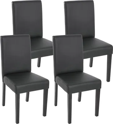 Four black dining chairs are arranged in a studio setting against a white background.