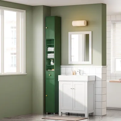 A modern bathroom with a green accent wall, featuring a tall green cabinet and a white vanity with a sink.