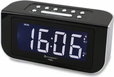 A black digital alarm clock with a silver trim, displaying the time and day.
