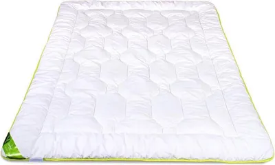 A white comforter with a green trim is shown on a white background.