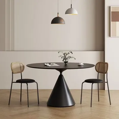 A dining table with two chairs in a modern room setting.