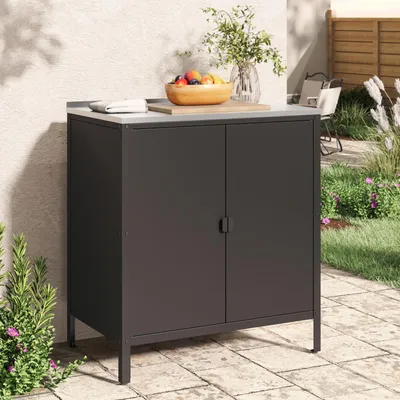 An outdoor cabinet is shown on a patio with plants and furniture in the background.