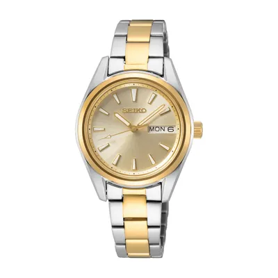 A close-up studio shot of a two-tone Seiko watch.