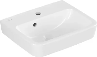 A white ceramic sink with two holes on the top surface.