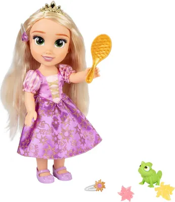 A doll of Rapunzel from Disney's Tangled, holding a golden brush, with accessories.
