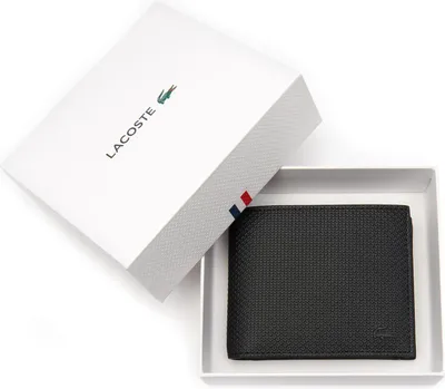 A black Lacoste wallet is presented in its white gift box.
