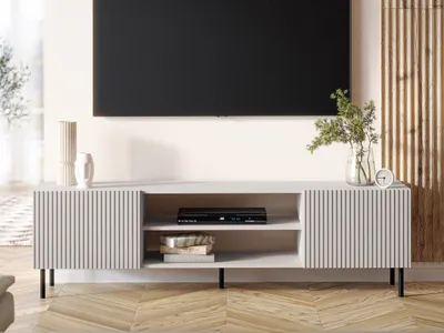 A modern living room with a TV mounted on the wall above a TV stand.