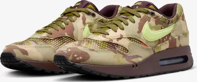 A pair of Nike Air Max '86 OG sneakers with a camouflage pattern.
