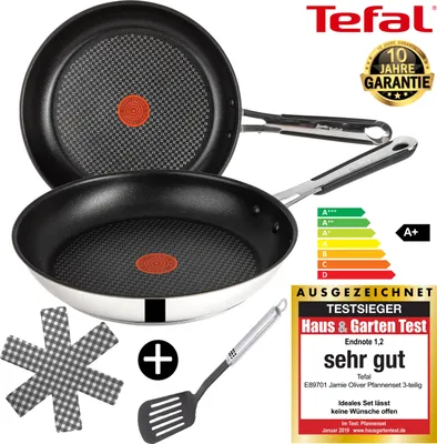 Two Tefal frying pans are shown, one stacked on top of the other, with a spatula and a protective mat. There are also marketing labels and an energy efficiency rating displayed.