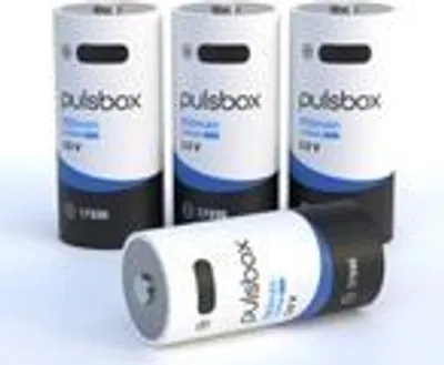 Several cylindrical batteries are arranged on a white surface, with one lying on its side in the foreground.