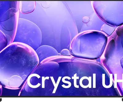 A close-up of a TV screen displaying abstract purple shapes and the text 'Crystal UH'.