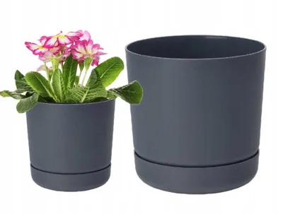 Two dark gray plant pots with saucers are shown against a white background. One pot contains a pink and white flowering plant.