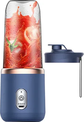 A blue portable smoothie maker with a clear blending cup filled with tomatoes and water, shown next to its blue lid.