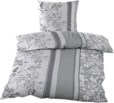 A folded duvet cover and pillowcase set with a floral pattern.
