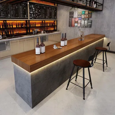 A bar counter with stools in a modern restaurant or cafe setting.
