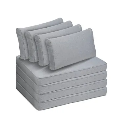 A stack of grey cushions and pillows on a white background.