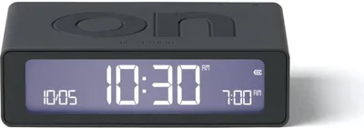 A dark gray digital alarm clock with a digital display showing the time.