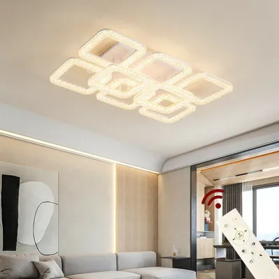 A modern living room with a sofa, artwork, and a ceiling light.