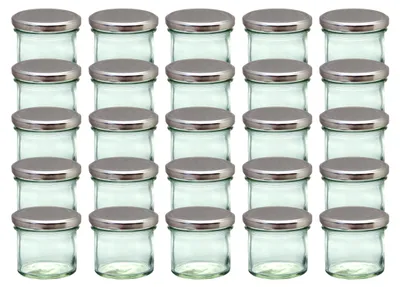 A grid of identical glass jars with silver lids.