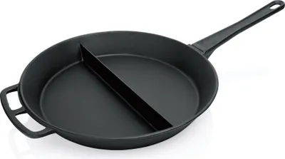A black cast iron frying pan with a divider is shown against a white background.