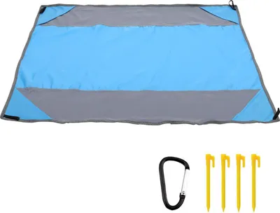A blue and gray picnic blanket laid out flat, with a carabiner and four yellow stakes below it.