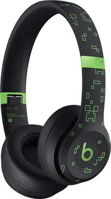 A pair of black Beats By Dre Solo 4 headphones with a Minecraft-themed green pixelated design.