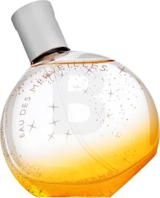 A perfume bottle with a gradient of gold and clear liquid, decorated with glittery stars.