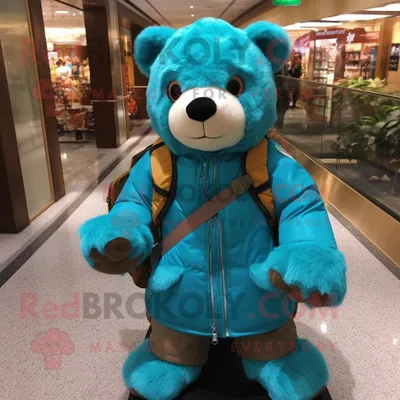 Produktbild von Türkiser REDBROKOLY Bär Maskottchen Kostüm charakter bekleidet mit einer Jacke und Rucksäcken