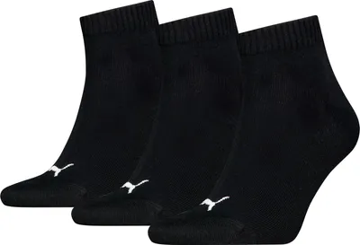 Three black Puma ankle socks are arranged in a slight diagonal on a white background.
