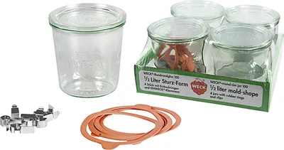 A collection of glass jars and accessories for canning or preserving.