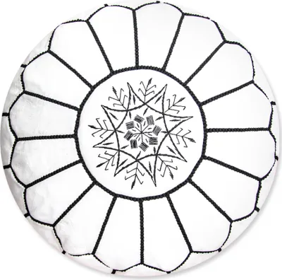 A white and black Moroccan leather pouf with intricate embroidery.