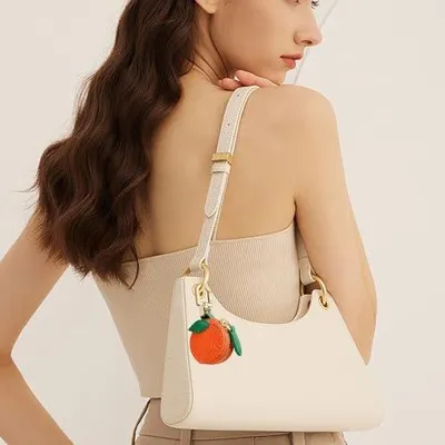 Produktbild von Mini-Geldbörse für Damen als Taschen- und Schlüsselanhänger, orangefarbener Münzbeutel aus Leder