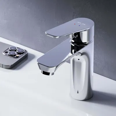 A chrome faucet is shown on a white sink, with a smartphone in the background.