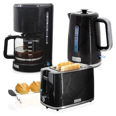 A set of kitchen appliances including a coffee maker, kettle, and toaster, along with some bread rolls.