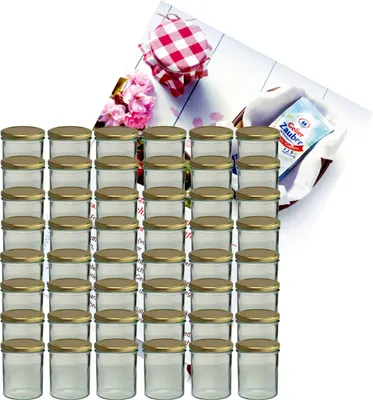 A large stack of small glass jars with gold lids, with a decorative checkered lid and flowers in the background.