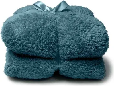 A folded teal blanket tied with a teal ribbon.