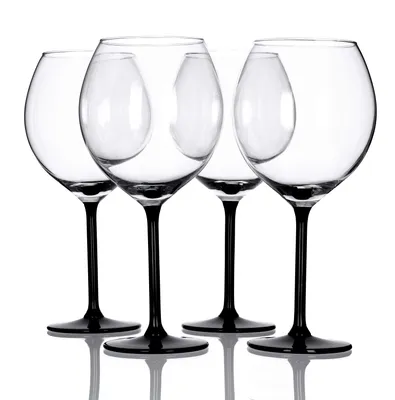 Four clear wine glasses with black stems and bases are arranged in a row against a white background.