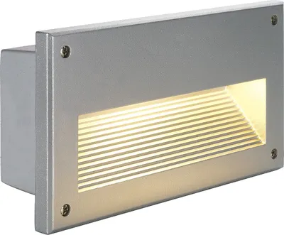 A silver-grey outdoor recessed light with a ribbed light cover.