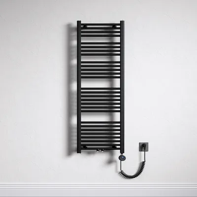 A black electric towel radiator mounted on a textured white wall, with a coiled power cord connecting to a wall socket.
