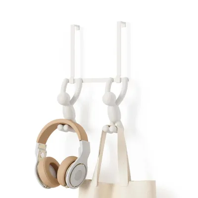 A white over-the-door hook rack with two figures holding up headphones and a tote bag.